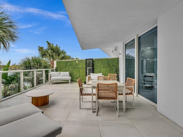 9821 E Bay Harbor Dr Unit 302, Bay Harbor Islands, FL 33154 - view of patio with outdoor dining space and a balcony