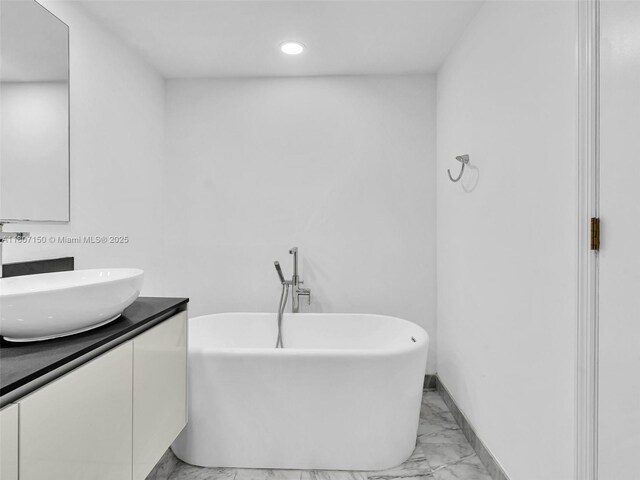 9821 E Bay Harbor Dr Unit 302, Bay Harbor Islands, FL 33154 - full bath with marble look tiles, a soaking tub, vanity, and recessed lighting