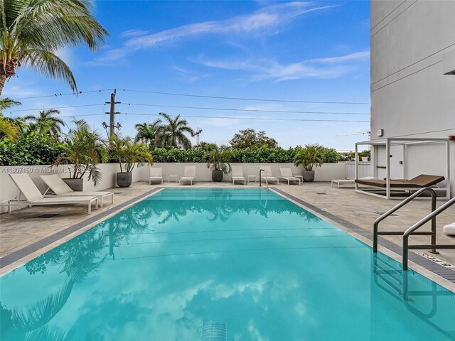 9821 E Bay Harbor Dr Unit 302, Bay Harbor Islands, FL 33154 - view of swimming pool featuring a patio area