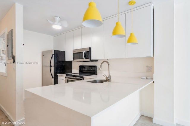 750 NE 64th St Unit B308, Miami, FL 33138 - kitchen with appliances with stainless steel finishes, a sink, white cabinetry, and baseboards