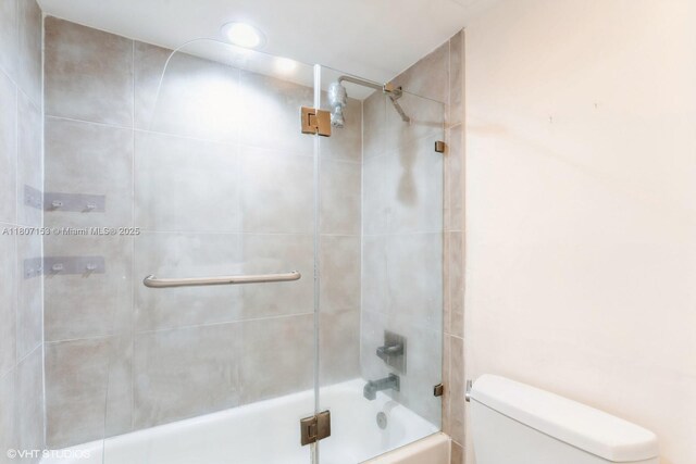 750 NE 64th St Unit B308, Miami, FL 33138 - bathroom featuring toilet and combined bath / shower with glass door