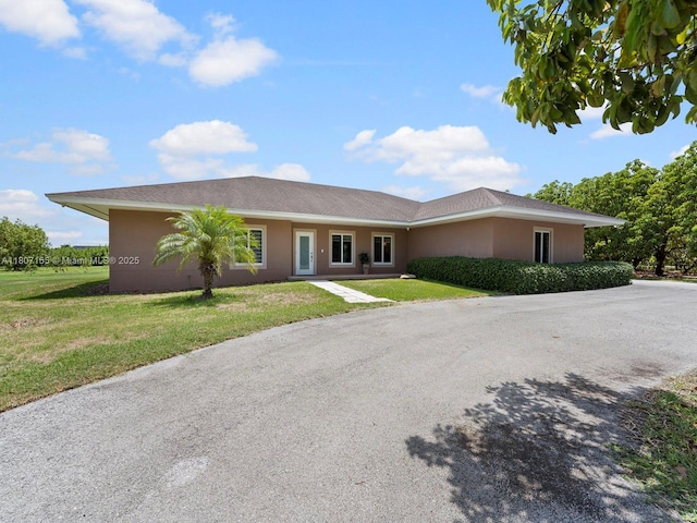 15150 SW 240th St, Homestead, FL 33032 - ranch-style home featuring a front yard and stucco siding