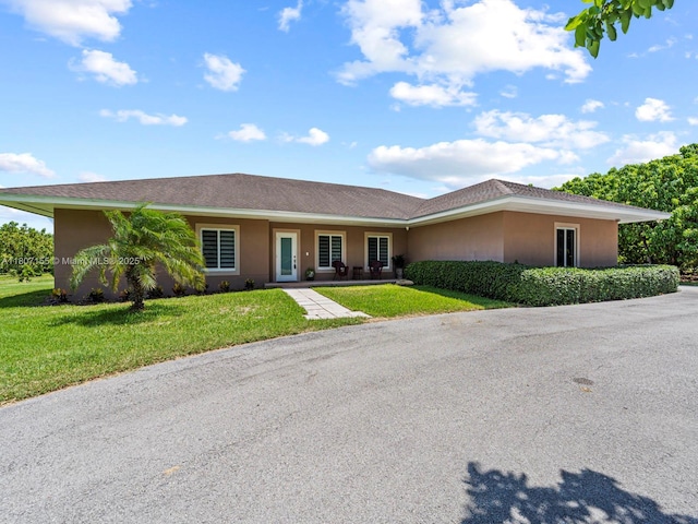 15150 SW 240th St, Homestead, FL 33032 - ranch-style house featuring stucco siding and a front yard