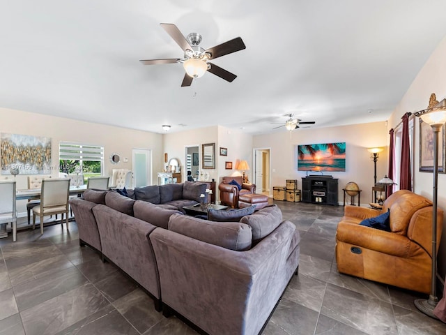 15150 SW 240th St, Homestead, FL 33032 - living room featuring ceiling fan and dark marble finish flooring