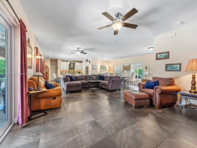 15150 SW 240th St, Homestead, FL 33032 - living room with a ceiling fan and dark tile patterned floors