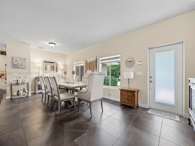 15150 SW 240th St, Homestead, FL 33032 - dining area featuring dark tile patterned floors and baseboards