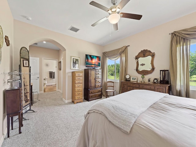 15150 SW 240th St, Homestead, FL 33032 - carpeted bedroom with arched walkways, baseboards, ensuite bathroom, and a ceiling fan