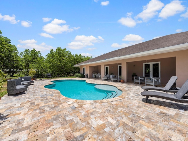 15150 SW 240th St, Homestead, FL 33032 - swimming pool featuring a patio, an outdoor living space, and french doors