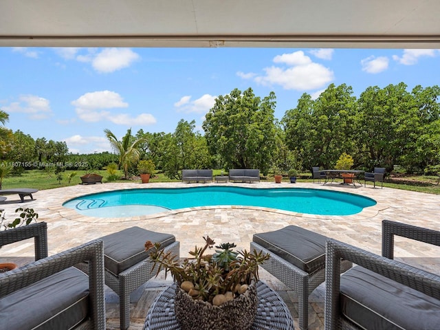15150 SW 240th St, Homestead, FL 33032 - swimming pool featuring a patio area, an outdoor living space, and view of scattered trees