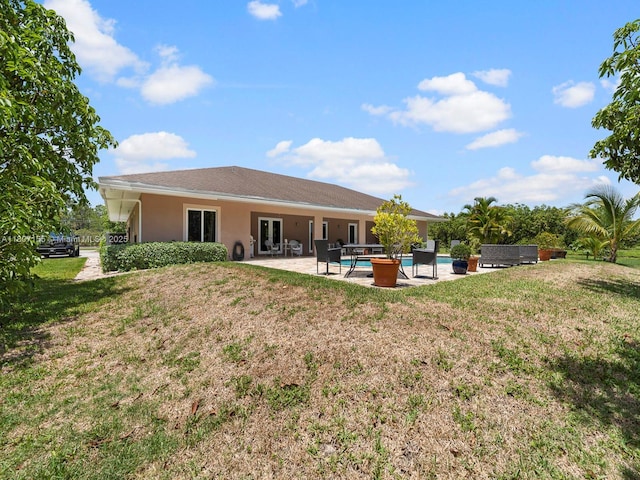 15150 SW 240th St, Homestead, FL 33032 - back of house featuring french doors, a yard, an outdoor pool, and a patio