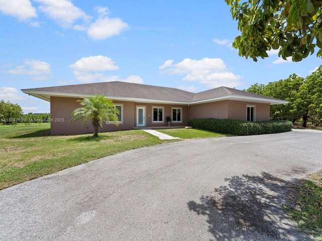 15150 SW 240th St, Homestead, FL 33032 - ranch-style home with a front lawn and stucco siding