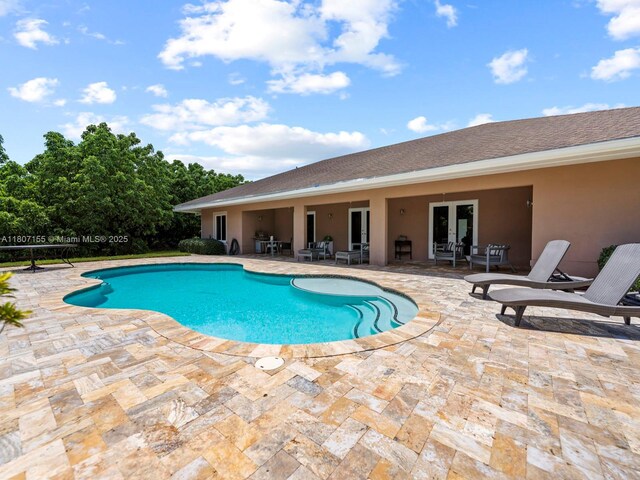 15150 SW 240th St, Homestead, FL 33032 - outdoor pool featuring french doors and a patio area