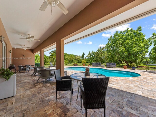 15150 SW 240th St, Homestead, FL 33032 - outdoor pool with ceiling fan, a patio area, and outdoor dining space