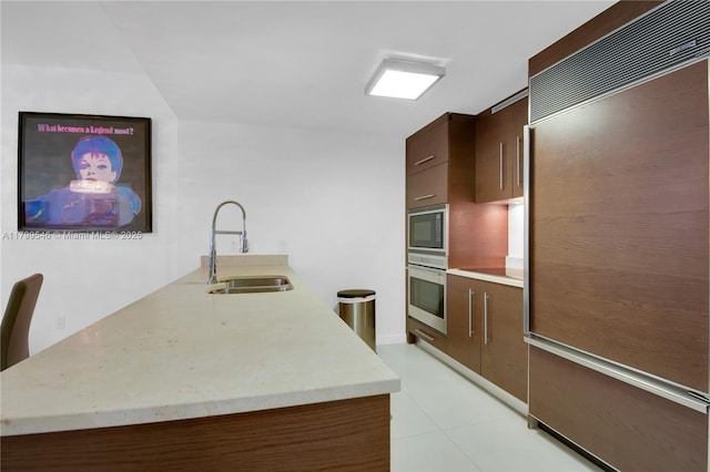 475 Brickell Ave Unit 4711, Miami, FL 33131 - kitchen featuring built in appliances, a sink, light countertops, modern cabinets, and light tile patterned flooring