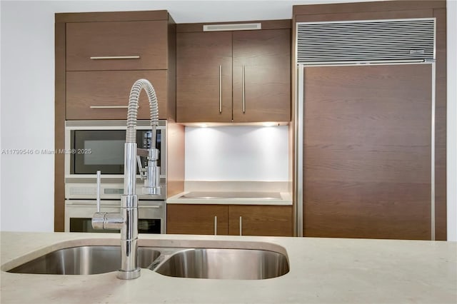 475 Brickell Ave Unit 4711, Miami, FL 33131 - kitchen featuring built in refrigerator and light stone counters