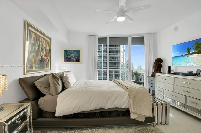 475 Brickell Ave Unit 4711, Miami, FL 33131 - tiled bedroom with expansive windows and ceiling fan