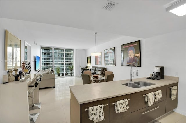475 Brickell Ave Unit 4711, Miami, FL 33131 - kitchen with a sink, open floor plan, light countertops, modern cabinets, and light tile patterned floors
