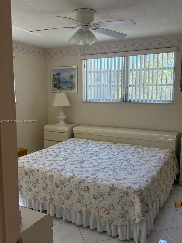 1395 NE 167th St Unit 203, Miami, FL 33162 - bedroom with ceiling fan and a textured ceiling