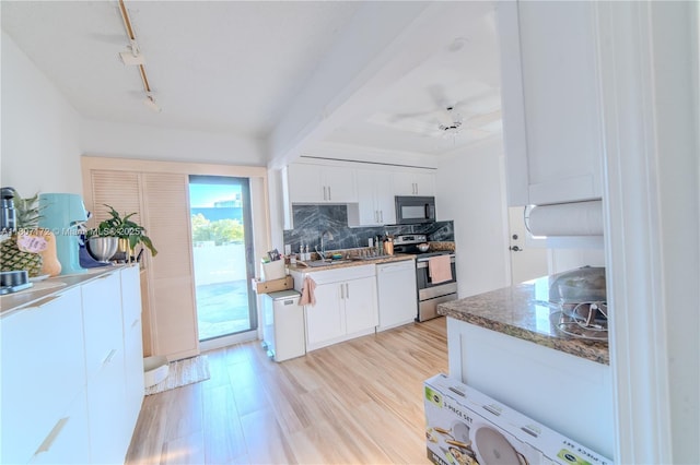 2924 Day Ave Unit Ph4N, Miami, FL 33133 - kitchen with electric stove, black microwave, backsplash, rail lighting, and white cabinets