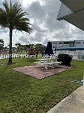 2200 N Park Ln Unit 311, Hollywood, FL 33021 - view of property's community with a patio and a lawn