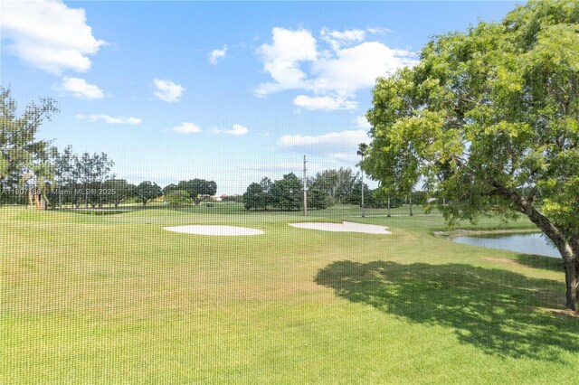 9220 S Hollybrook Lake Dr Unit 208, Pembroke Pines, FL 33025 - view of property's community with view of golf course, a water view, and a lawn