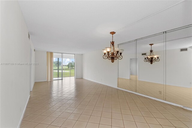 9220 S Hollybrook Lake Dr Unit 208, Pembroke Pines, FL 33025 - spare room with a chandelier, expansive windows, baseboards, and light tile patterned floors