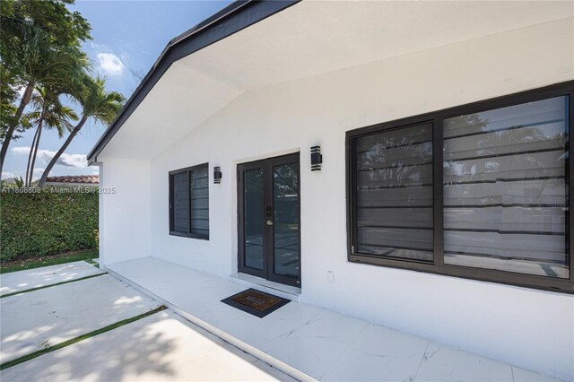 9240 SW 57th Ter, Miami, FL 33173 - view of exterior entry featuring french doors, stucco siding, and a patio