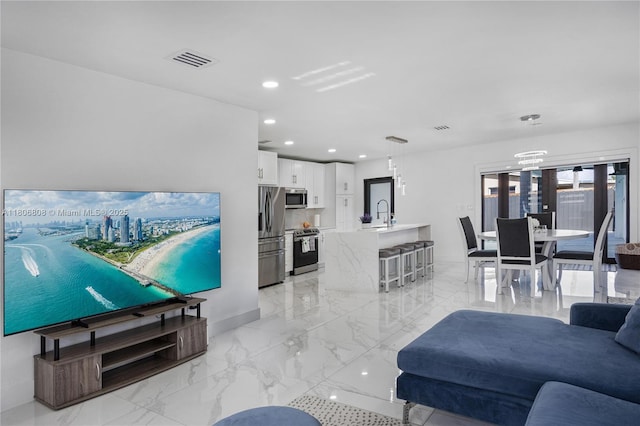 9240 SW 57th Ter, Miami, FL 33173 - living room featuring recessed lighting, light marble finish floors, and baseboards
