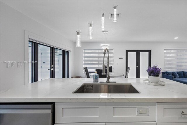 9240 SW 57th Ter, Miami, FL 33173 - kitchen with french doors, open floor plan, a sink, and light stone countertops