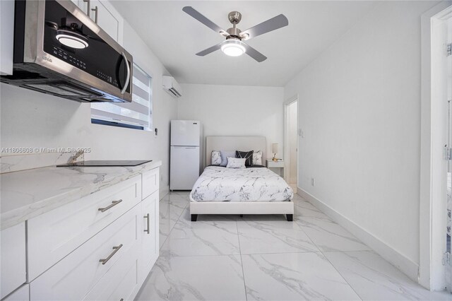 9240 SW 57th Ter, Miami, FL 33173 - bedroom with freestanding refrigerator, a wall mounted air conditioner, light marble finish floors, a ceiling fan, and baseboards