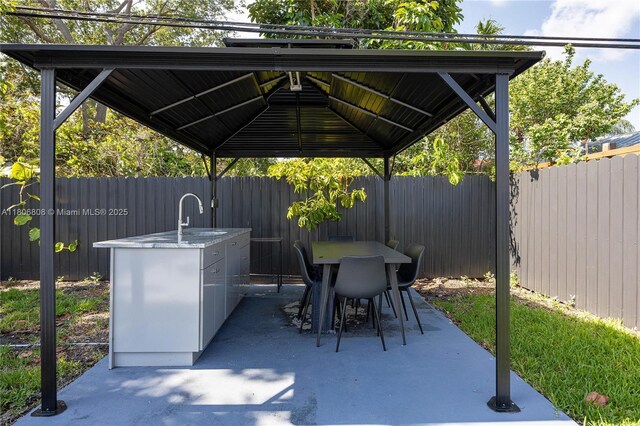 9240 SW 57th Ter, Miami, FL 33173 - fenced backyard featuring a patio, outdoor dining area, and a sink