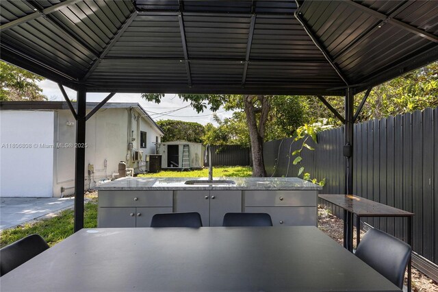 9240 SW 57th Ter, Miami, FL 33173 - fenced backyard featuring a sink, outdoor dining area, and a patio