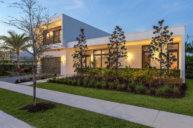 16703 S Botaniko Dr S, Weston, FL 33326 - contemporary home with driveway, a front lawn, a balcony, stucco siding, and a garage