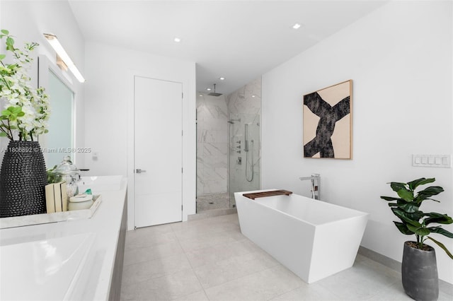 16703 S Botaniko Dr S, Weston, FL 33326 - bathroom featuring a marble finish shower, a freestanding bath, double vanity, recessed lighting, and baseboards