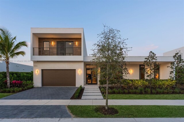 16703 S Botaniko Dr S, Weston, FL 33326 - contemporary home with a garage, stucco siding, a balcony, and decorative driveway
