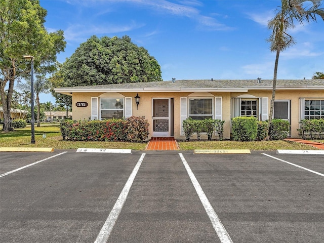 13785 Flora Pl Unit A, Delray Beach, FL 33484 - view of front of property featuring stucco siding and uncovered parking