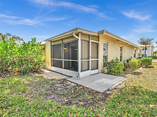 13785 Flora Pl Unit A, Delray Beach, FL 33484 - rear view of house with a sunroom and stucco siding