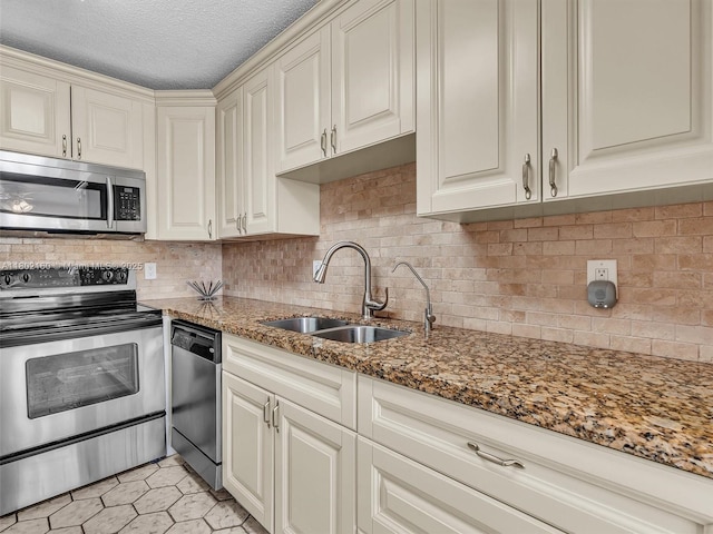 13785 Flora Pl Unit A, Delray Beach, FL 33484 - kitchen featuring stainless steel appliances, a textured ceiling, stone countertops, and tasteful backsplash