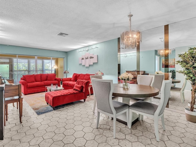 13785 Flora Pl Unit A, Delray Beach, FL 33484 - dining area featuring a chandelier and a textured ceiling