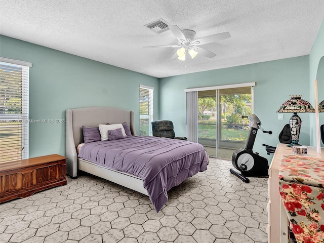 13785 Flora Pl Unit A, Delray Beach, FL 33484 - bedroom featuring access to outside, a textured ceiling, and ceiling fan