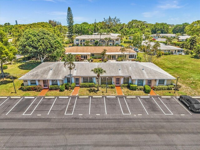 13785 Flora Pl Unit A, Delray Beach, FL 33484 - view of subject property featuring a tree filled landscape