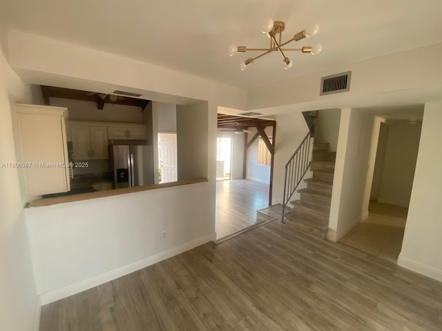 8015 SW 21st Ct, Davie, FL 33324 - unfurnished living room featuring a chandelier, stairs, wood finished floors, and baseboards