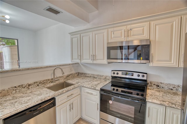 8015 SW 21st Ct, Davie, FL 33324 - kitchen with stainless steel appliances, a sink, and light stone counters