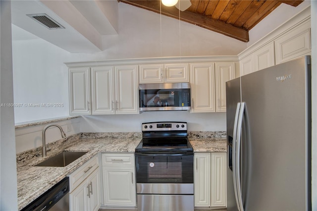 8015 SW 21st Ct, Davie, FL 33324 - kitchen featuring stainless steel appliances, a sink, wooden ceiling, light stone counters, and white cabinetry