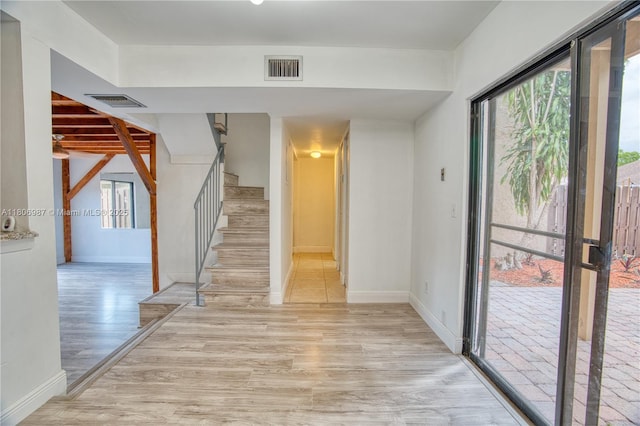 8015 SW 21st Ct, Davie, FL 33324 - foyer with light wood finished floors, stairs, and baseboards