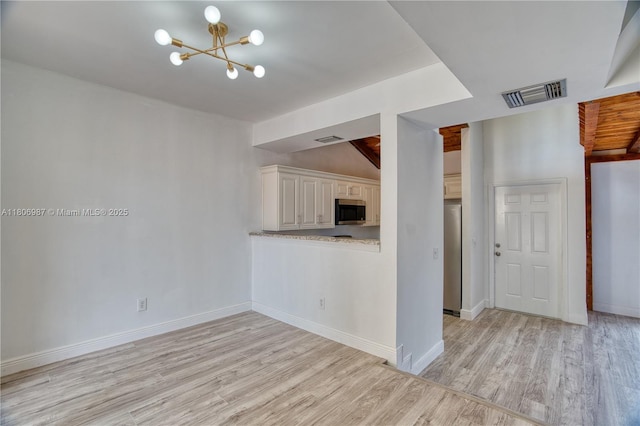 8015 SW 21st Ct, Davie, FL 33324 - kitchen featuring stainless steel appliances, light wood-style floors, a chandelier, and baseboards