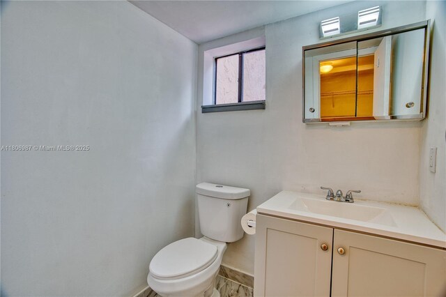 8015 SW 21st Ct, Davie, FL 33324 - half bathroom featuring toilet, vanity, and baseboards