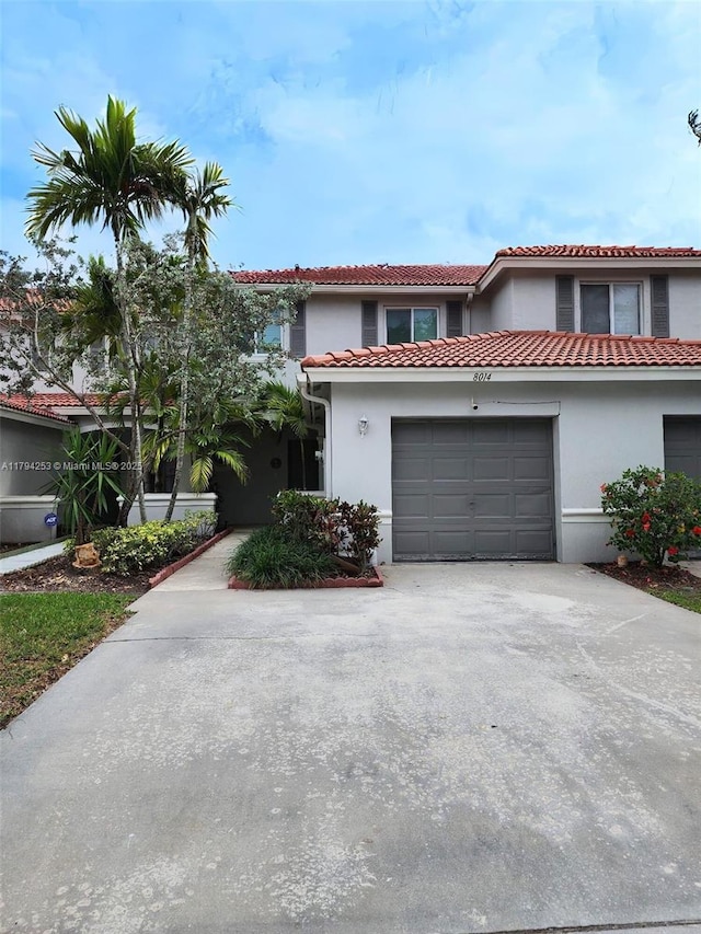 8014 Big Pine Way, Riviera Beach, FL 33407 - view of front facade featuring a garage, driveway, stucco siding, and a tiled roof