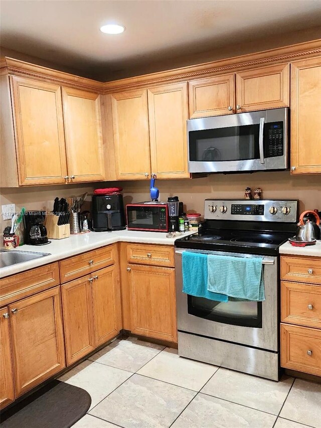8014 Big Pine Way, Riviera Beach, FL 33407 - kitchen with appliances with stainless steel finishes, light tile patterned floors, and light countertops