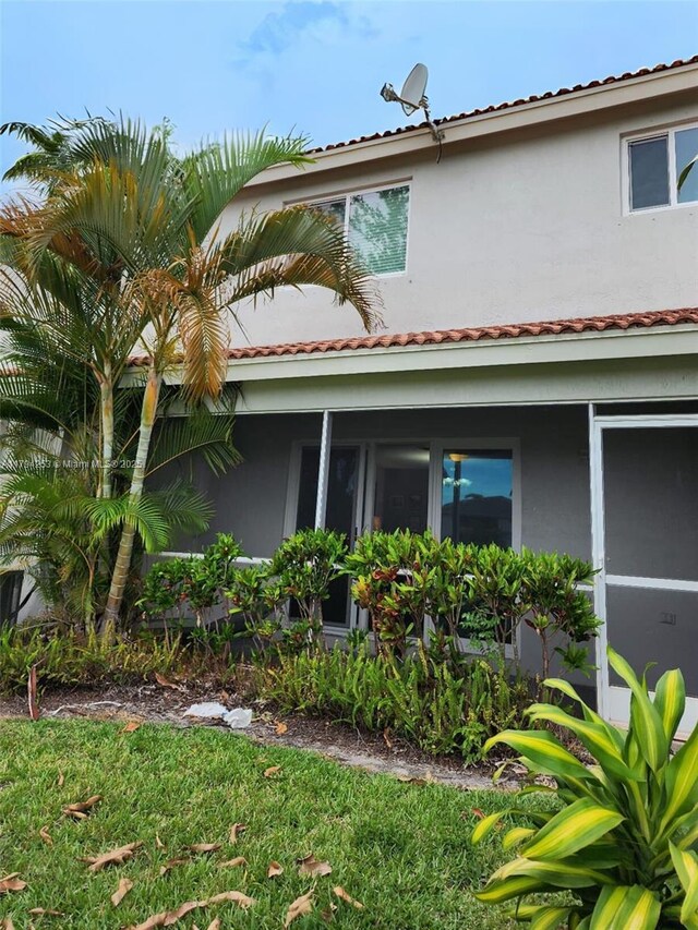 8014 Big Pine Way, Riviera Beach, FL 33407 - rear view of house with stucco siding and a tiled roof